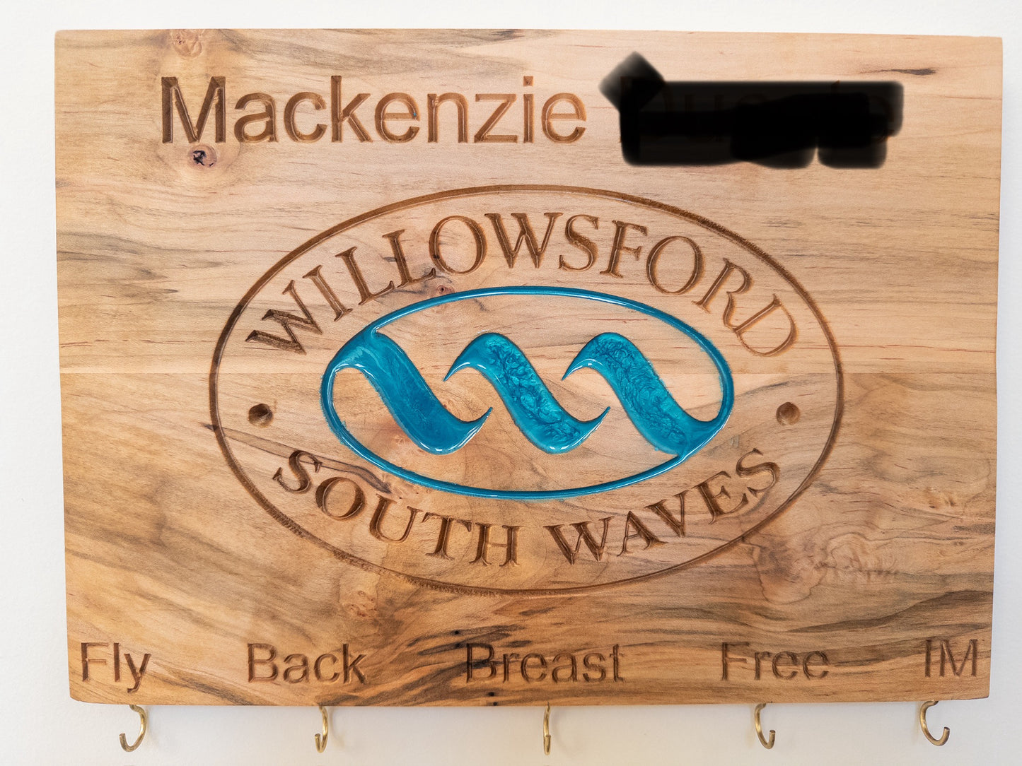 Handcrafted maple personalized swimming achievement board for Willowsford South Waves team with custom engraved swimmer's name