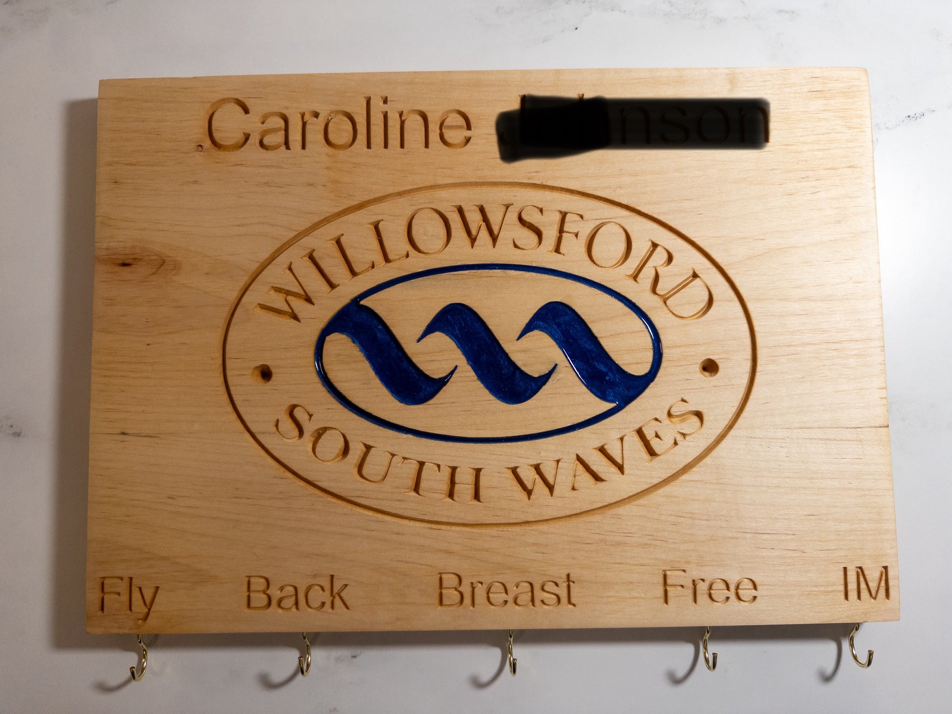 Handcrafted maple personalized swimming achievement board for Willowsford South Waves team with custom engraved swimmer's name