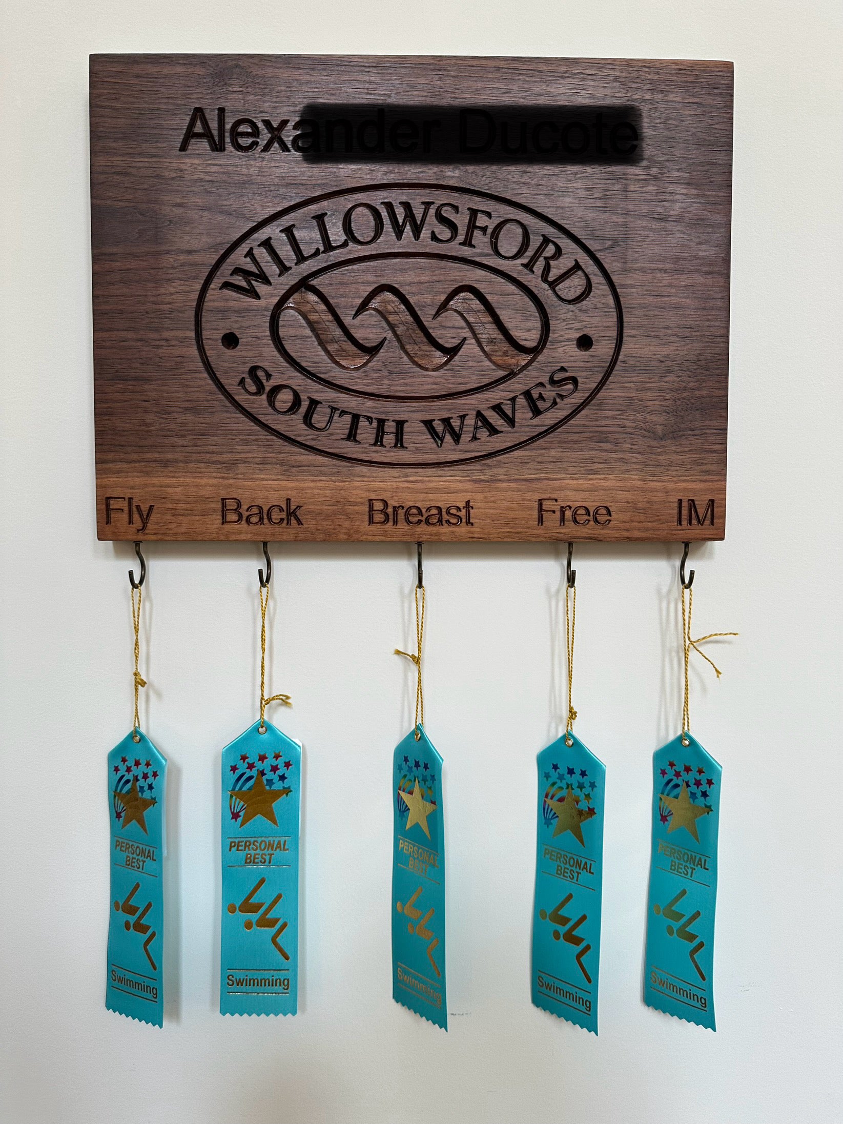 Handcrafted maple personalized swimming achievement board for Willowsford South Waves team with custom engraved swimmer's name